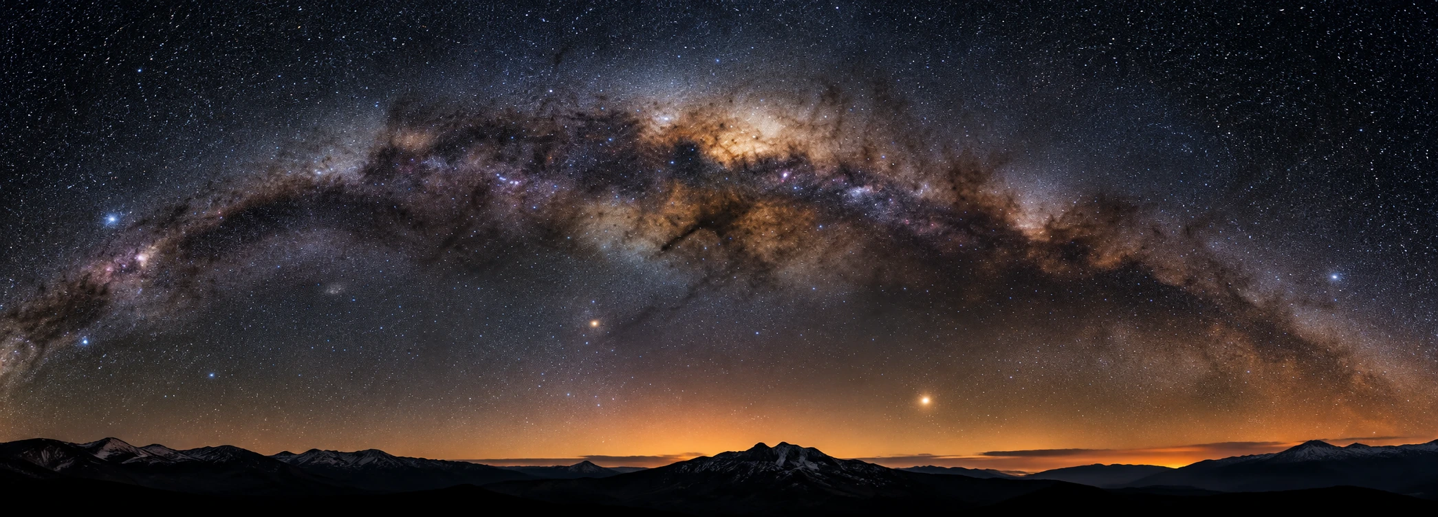 Milky Way arch above a mountain horizon